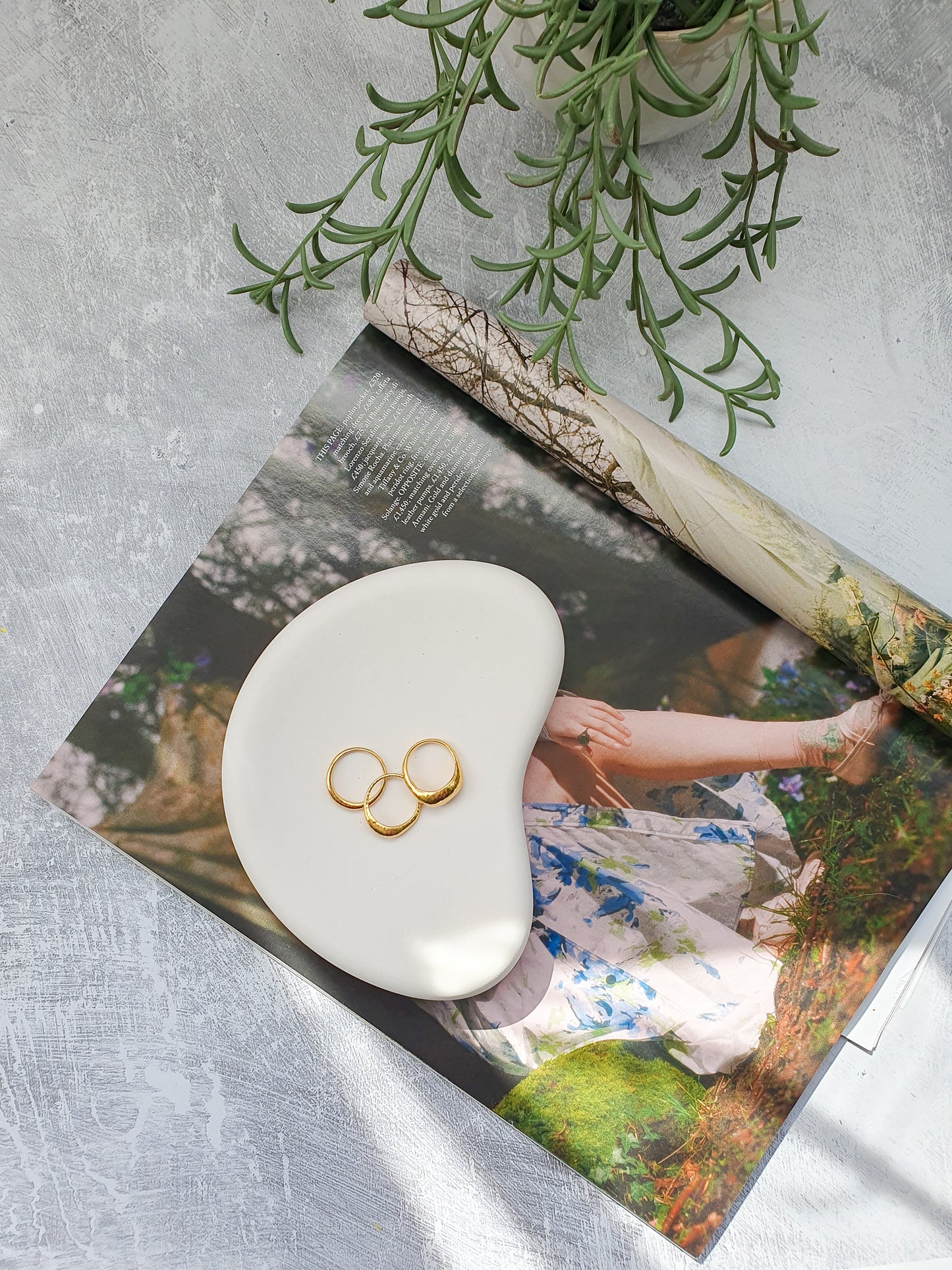 Irregular Jewellery Tray on a magazine with rings on it.
