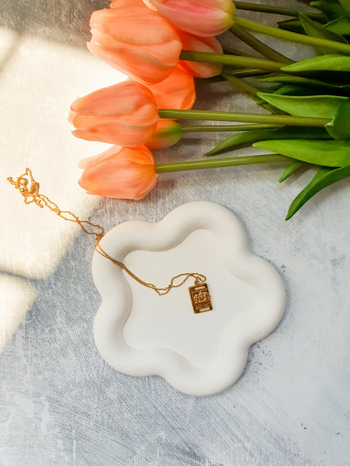 Flower Shaped Trinket Tray neckless in it pink tulips on the side.