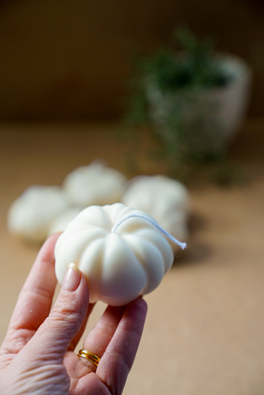 Holding ivory pumpkin candle
