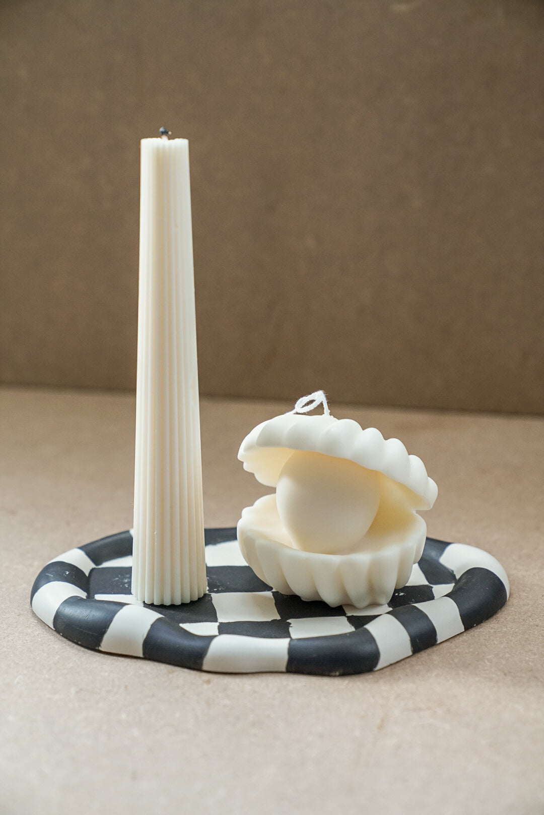 Large Clam Shell W/ Pearl Candle and tall pillar candle on a curvy trinket tray.