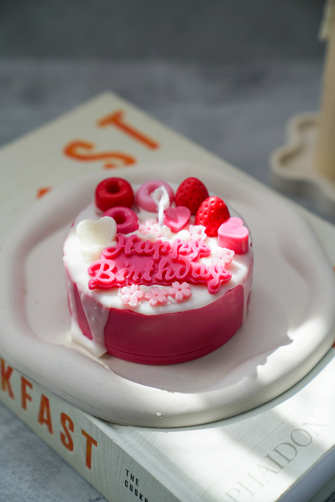 Not edible pink Birthday Cake Candle on a trinket dish.