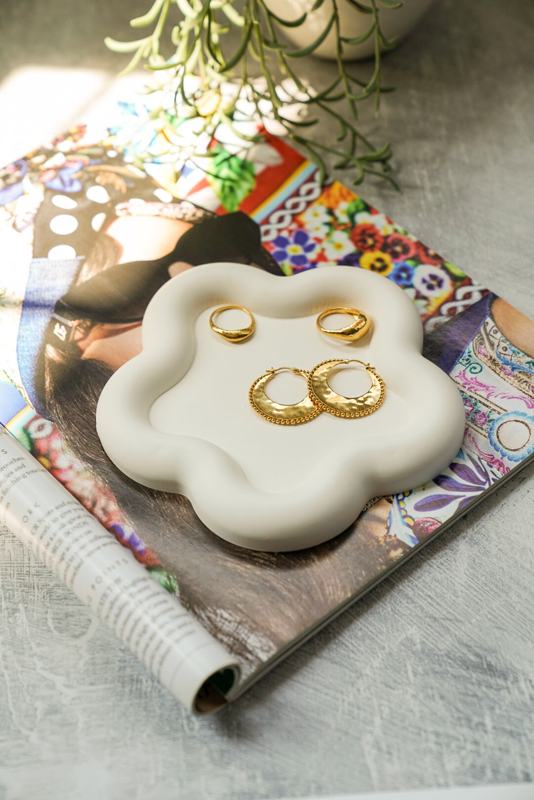 Off white Flower Shaped Trinket Tray with jewellery on it.