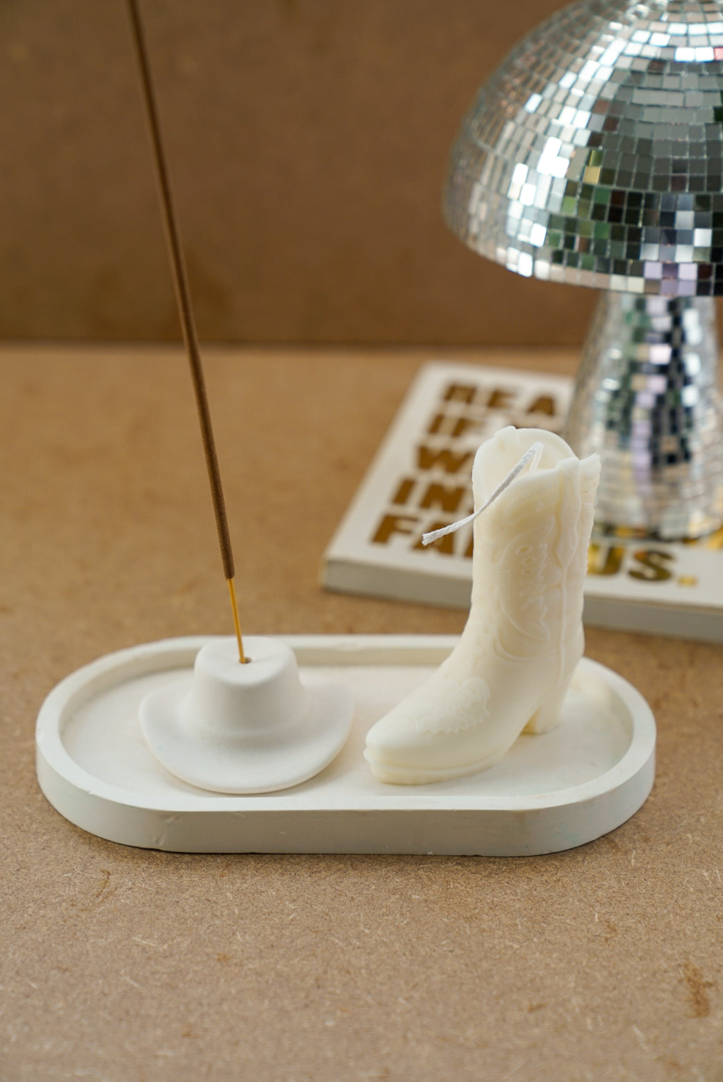 Ivory Cowboy Boots Candle and Off White Cowboy Hat incense holder with incense in it.