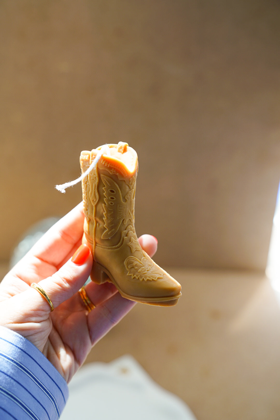 Holding Brown Cowboy Boot Candle
