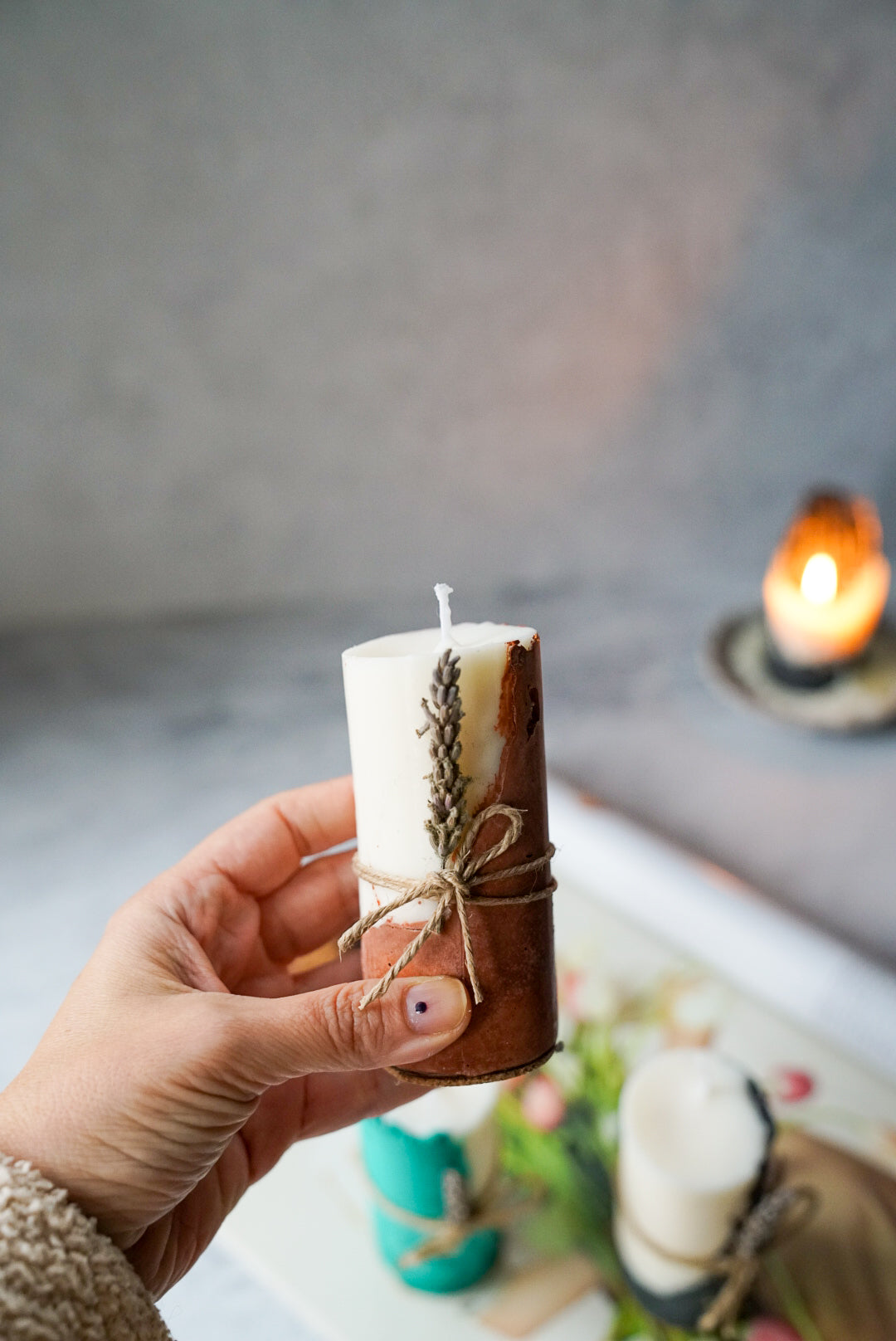 Holding Brown Concrete Soy Wax Candles With Lavender Scented