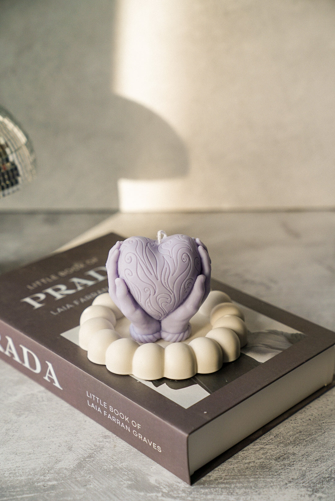 Hands Holding A Heart Candle in a bubble trinket tray.