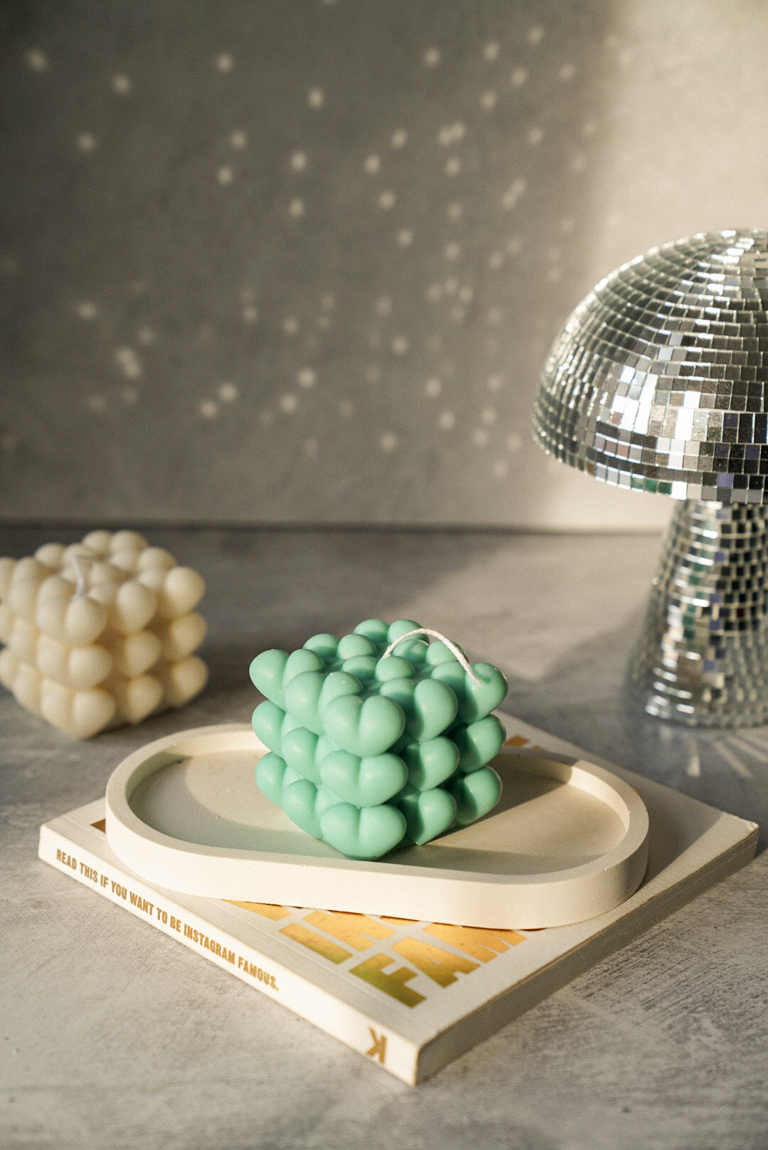 Heart Cube Candle in a trinket tray with mushroom disco ball on the back.