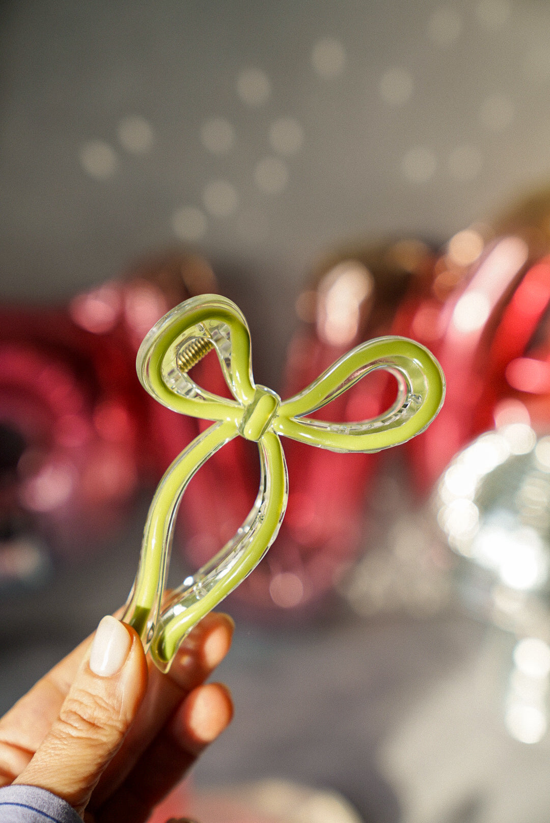 Holding Green Bow Claw Clip