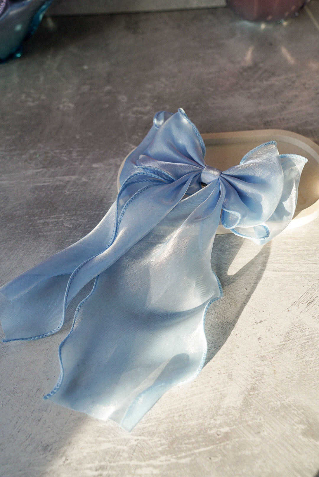 Baby blue Bow Tie Hair Clip is in white trinket tray