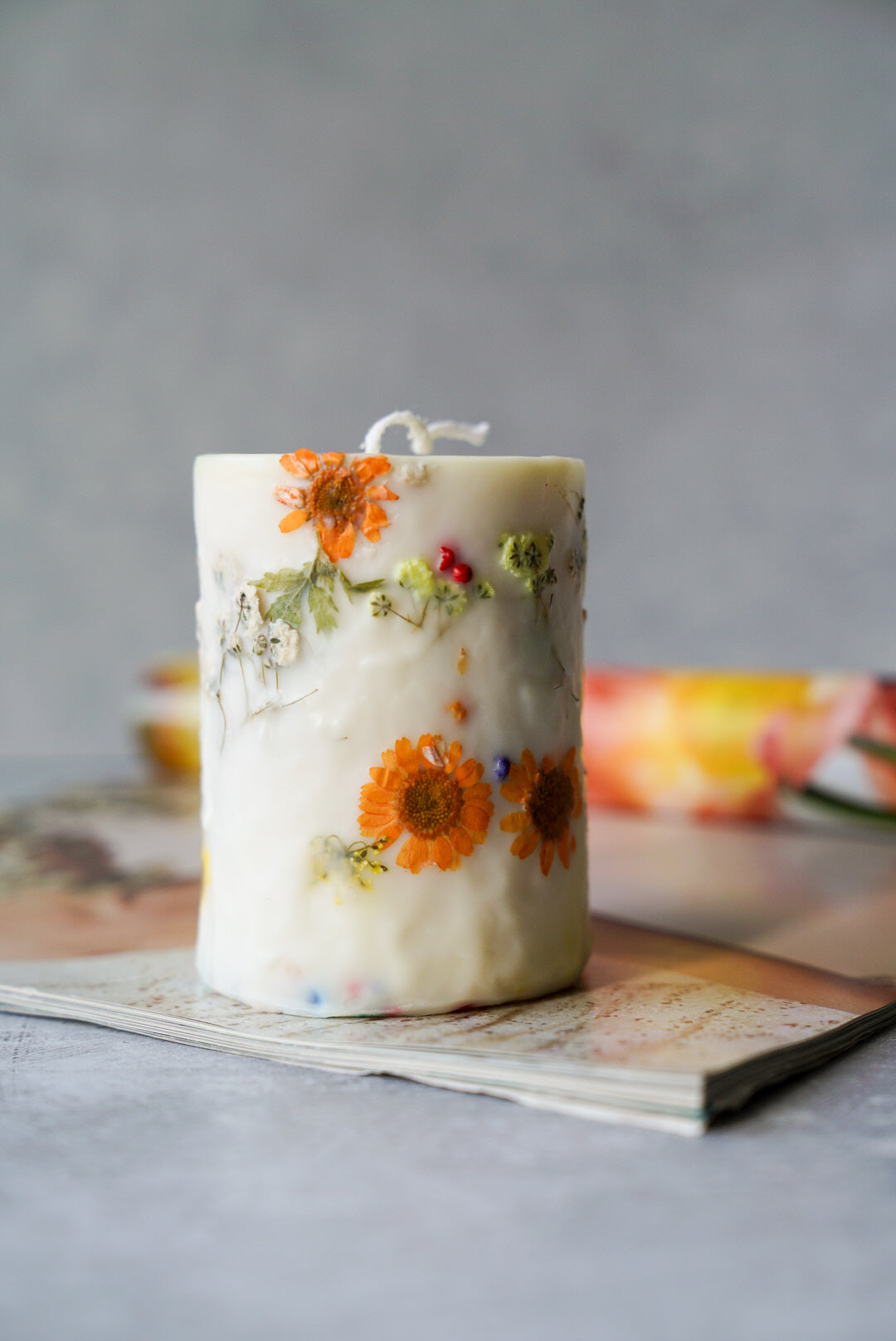Flower detailed candle on a magazine