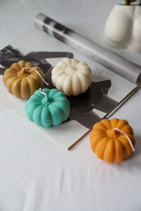 Halloween Pumpkin Candles on a magazine.