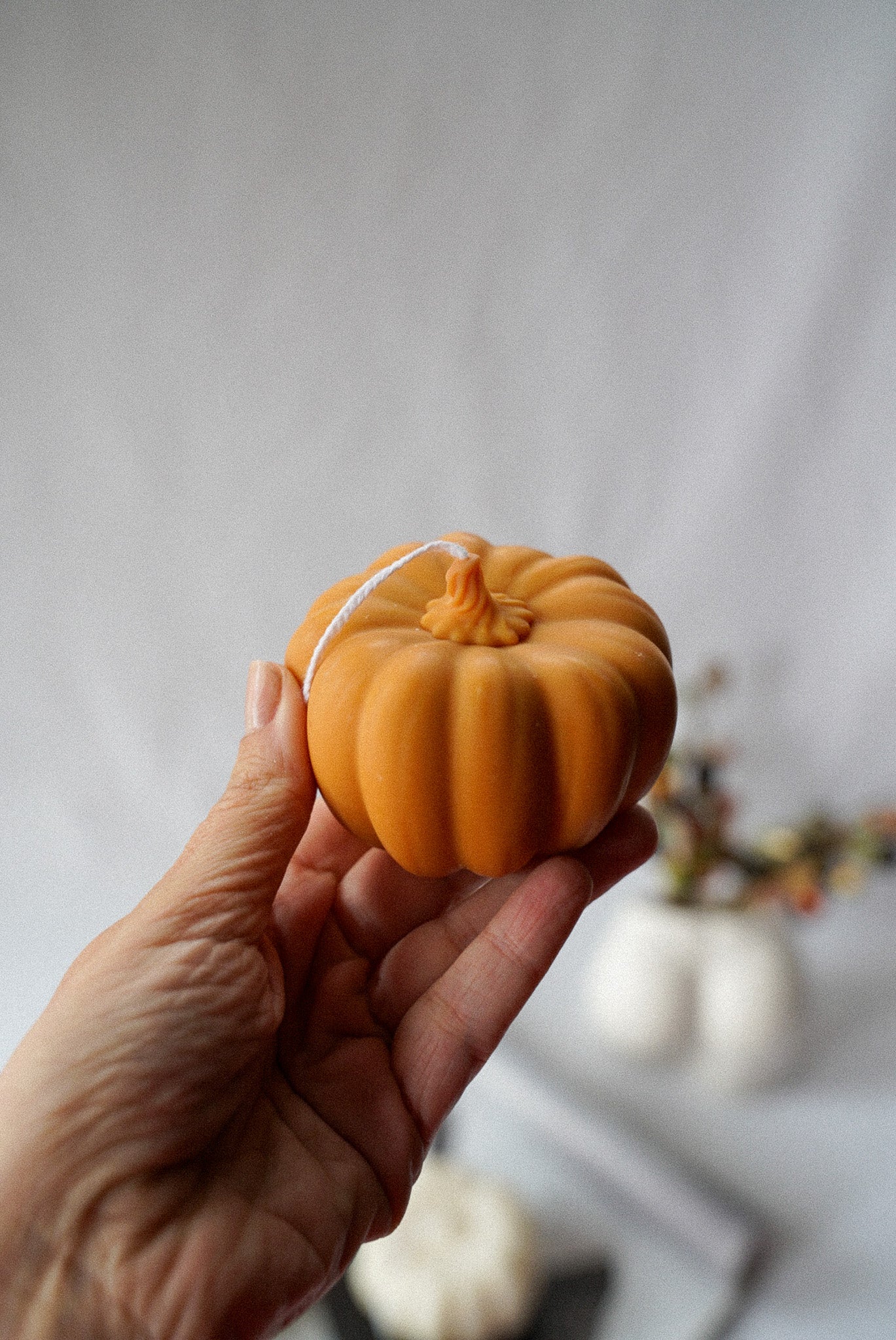 Holding Halloween Pumpkin Candle.