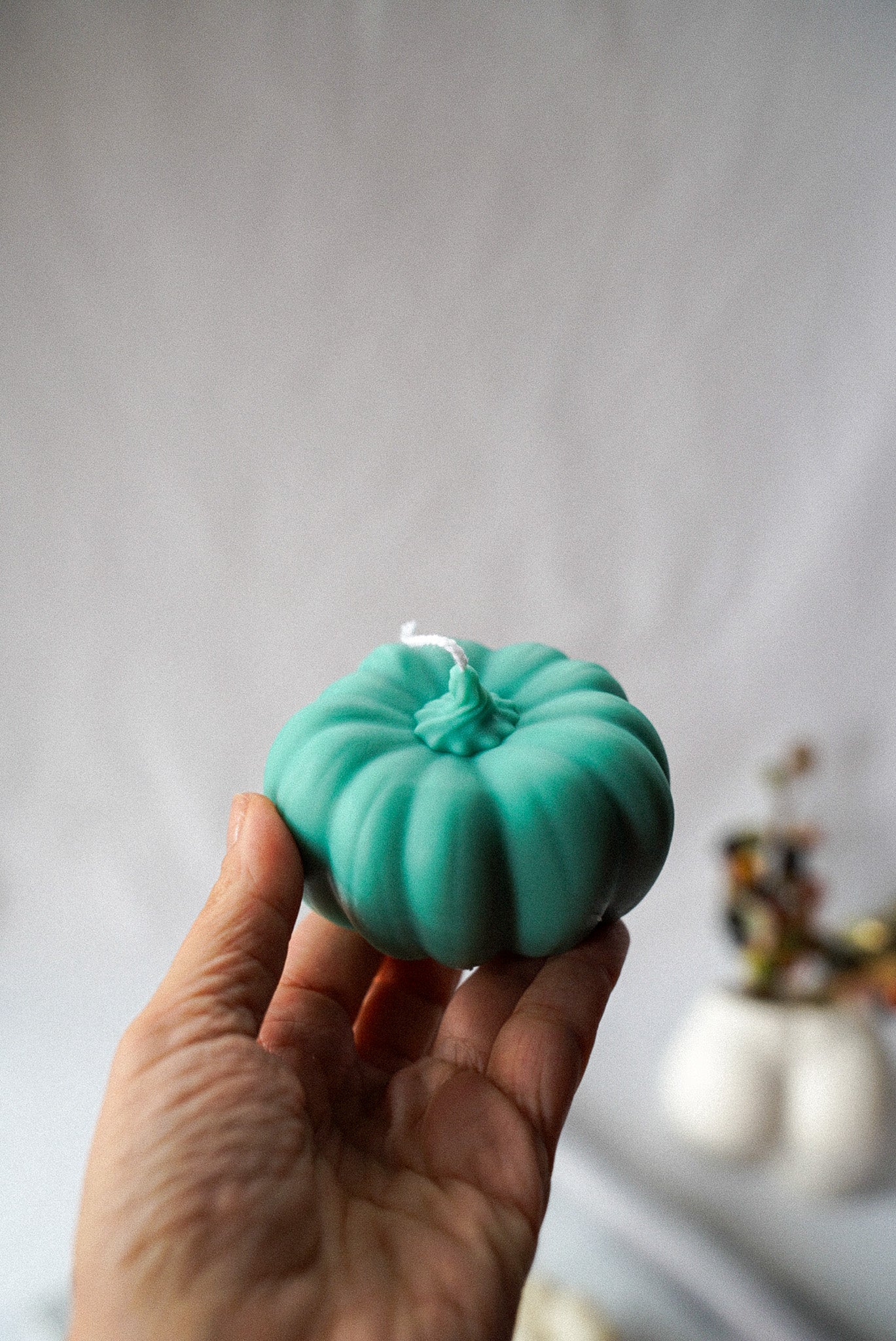Holding green Halloween Pumpkin Candle.