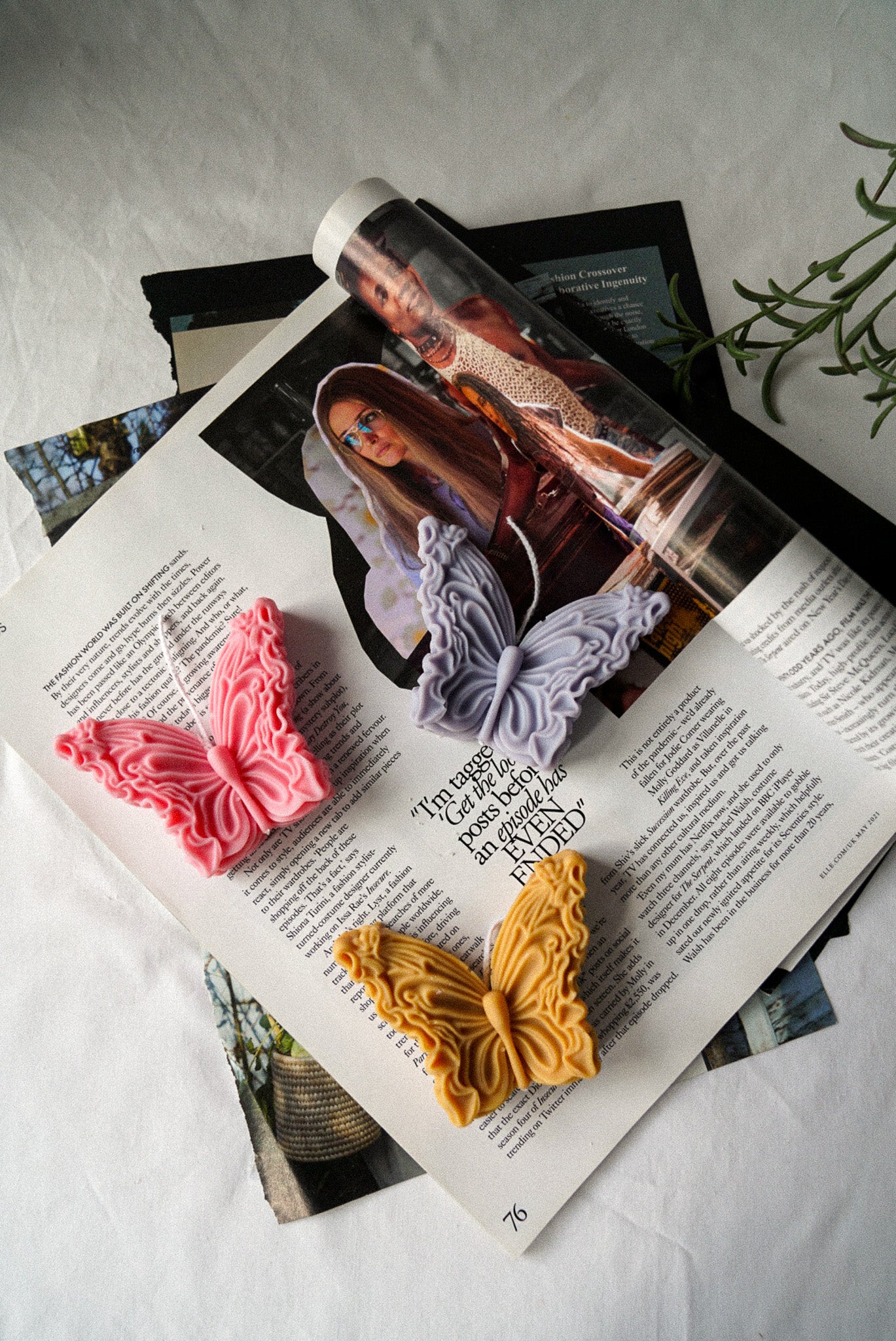 Butterfly Soy Wax Candles sitting on a newspaper