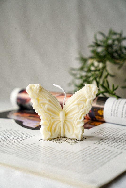 Ivory Butterfly Soy Wax Candle green plants on the background