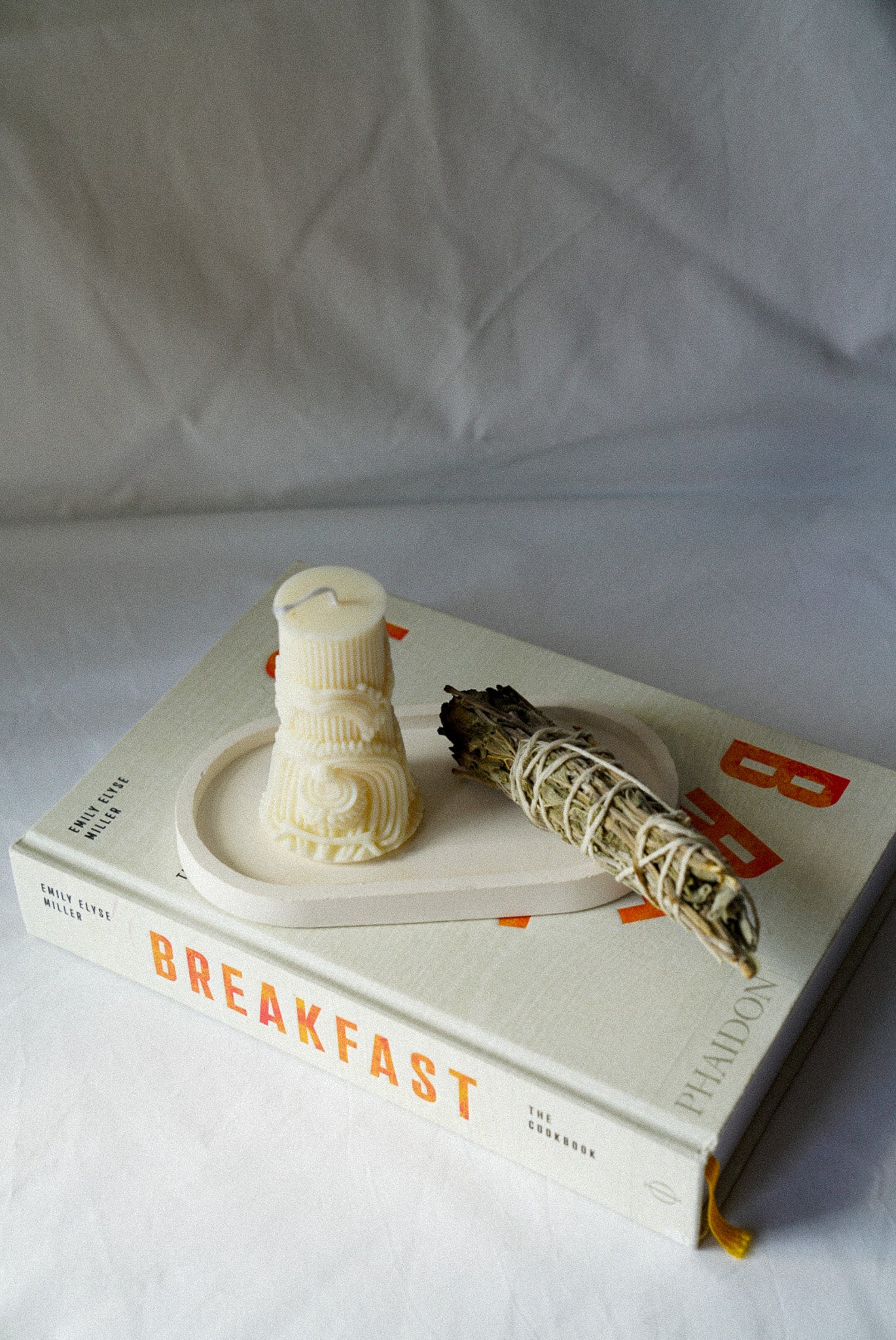 Carved Cylindrical Pillar Candle with sage stick next to it