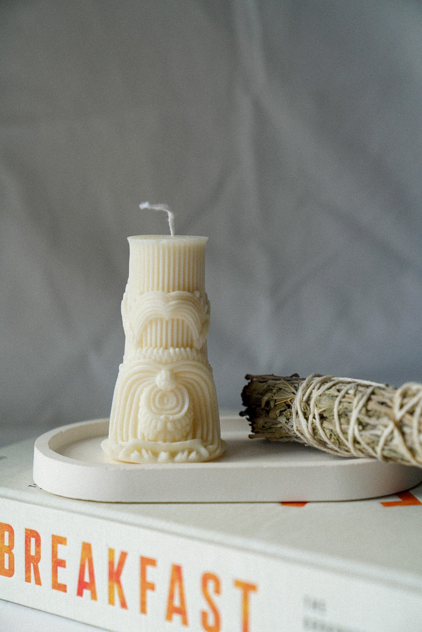 Carved Cylindrical Pillar Candle with sage stick next to it