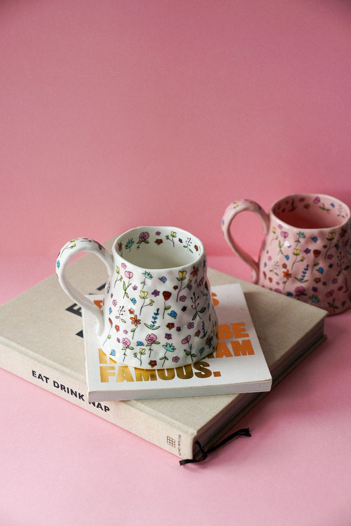 White Flower Ceramic Coffee Cup / Tea Mugs sitting on magazine