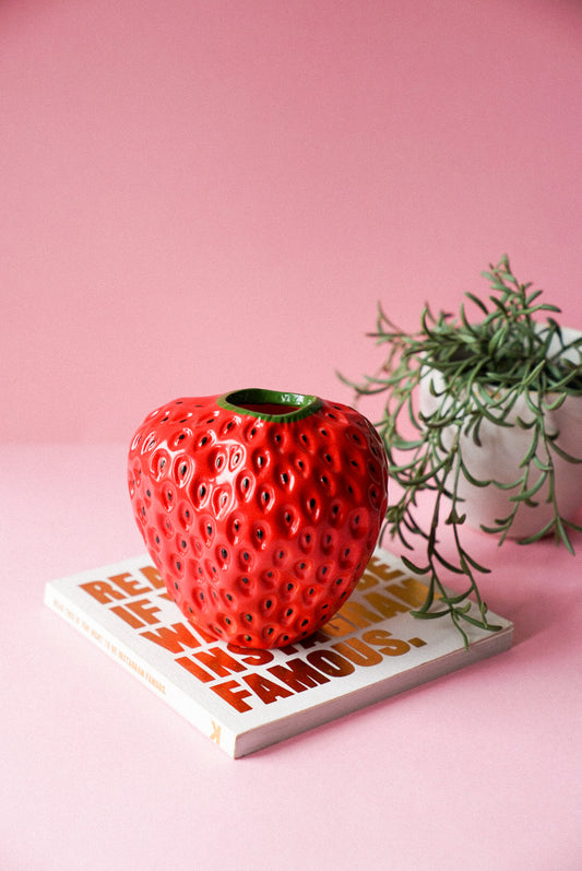 Red Strawberry Shaped Vase with pink background.
