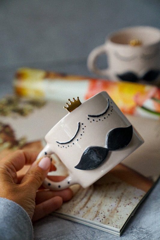 Holding Mr King coffee mug