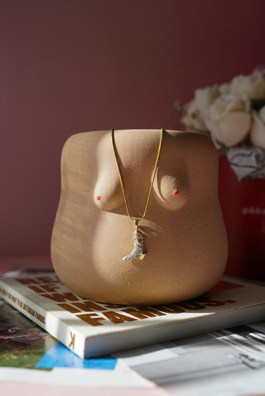 Mannequin bust with a necklace on a magazine