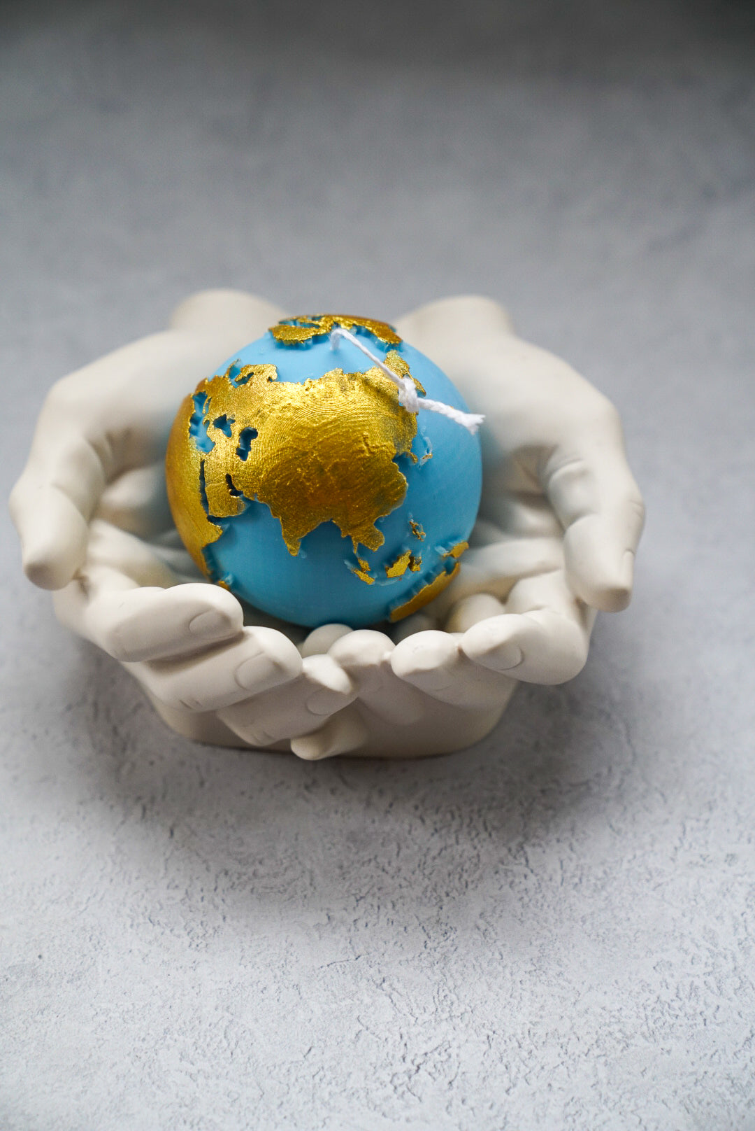 Blue Globe Candle with gold painted on a hand stoneware