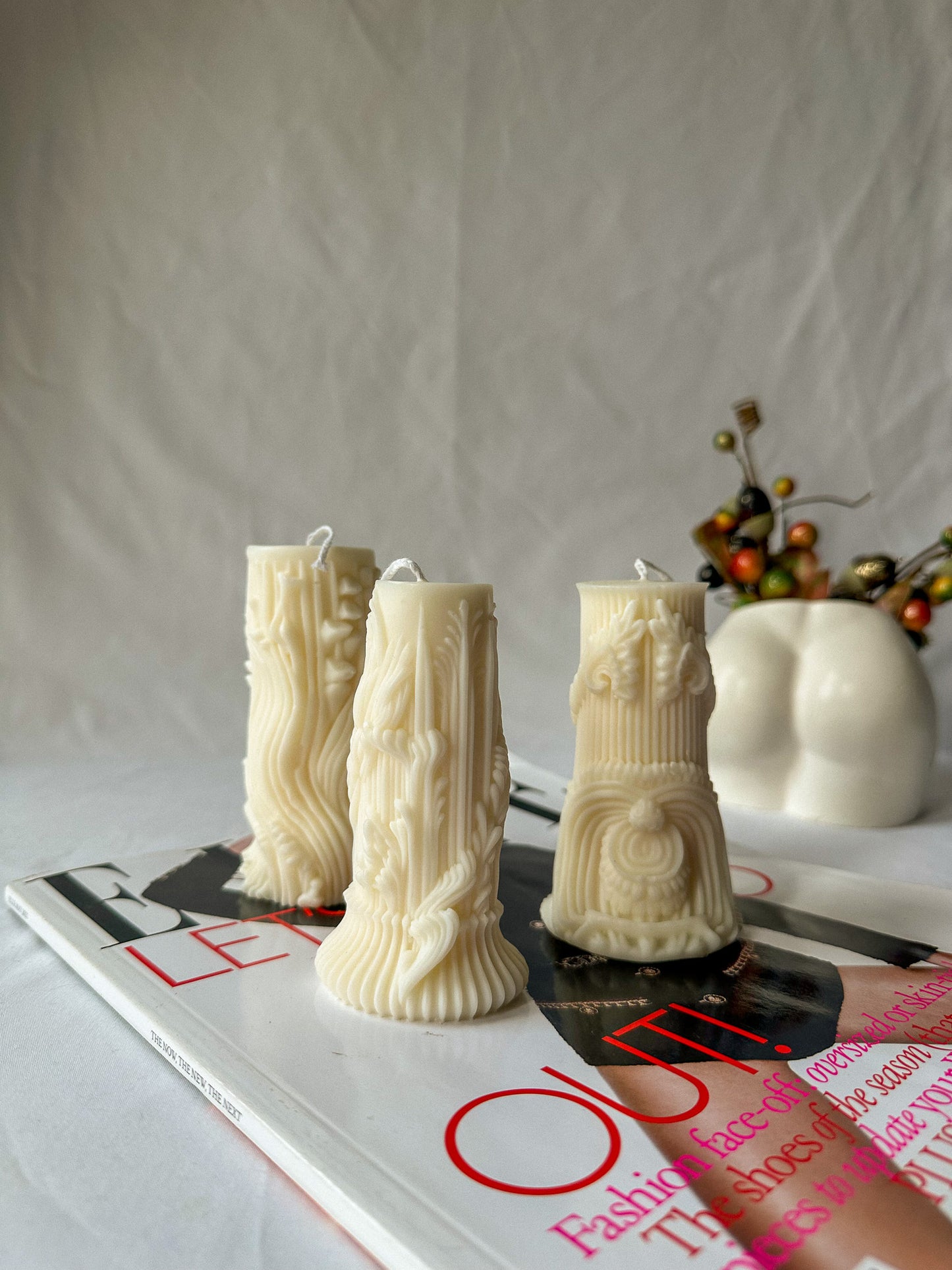 Carved Cylindrical Pillar Candle on a magazine