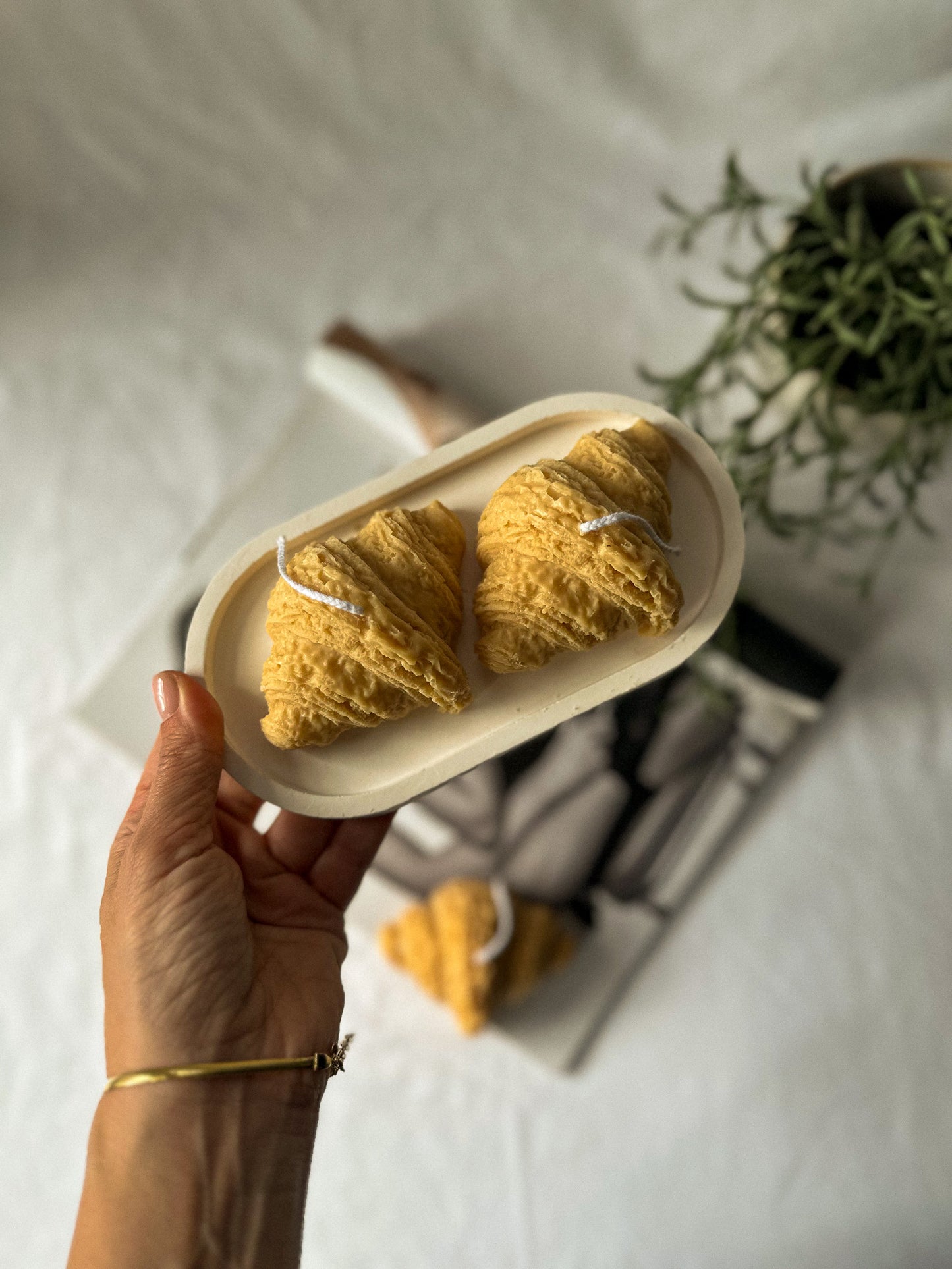 Croissant Shaped Soy Wax Candles on a trinket dish.