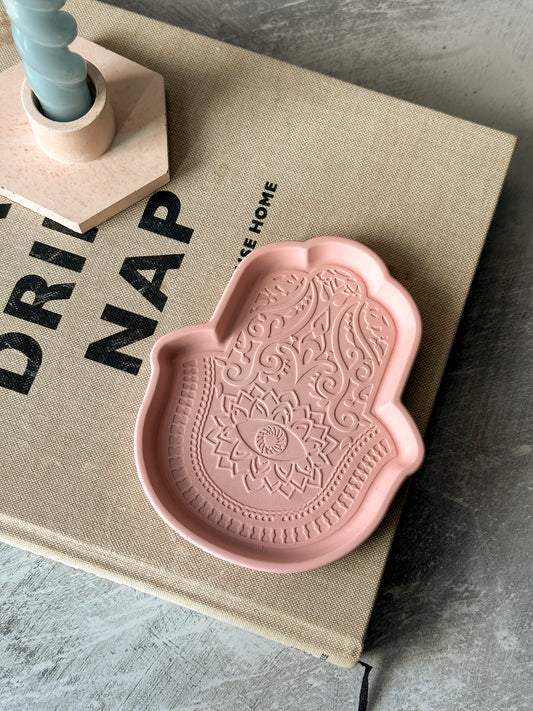 Pink Fatima Hand Jewellery Tray on a magazine.