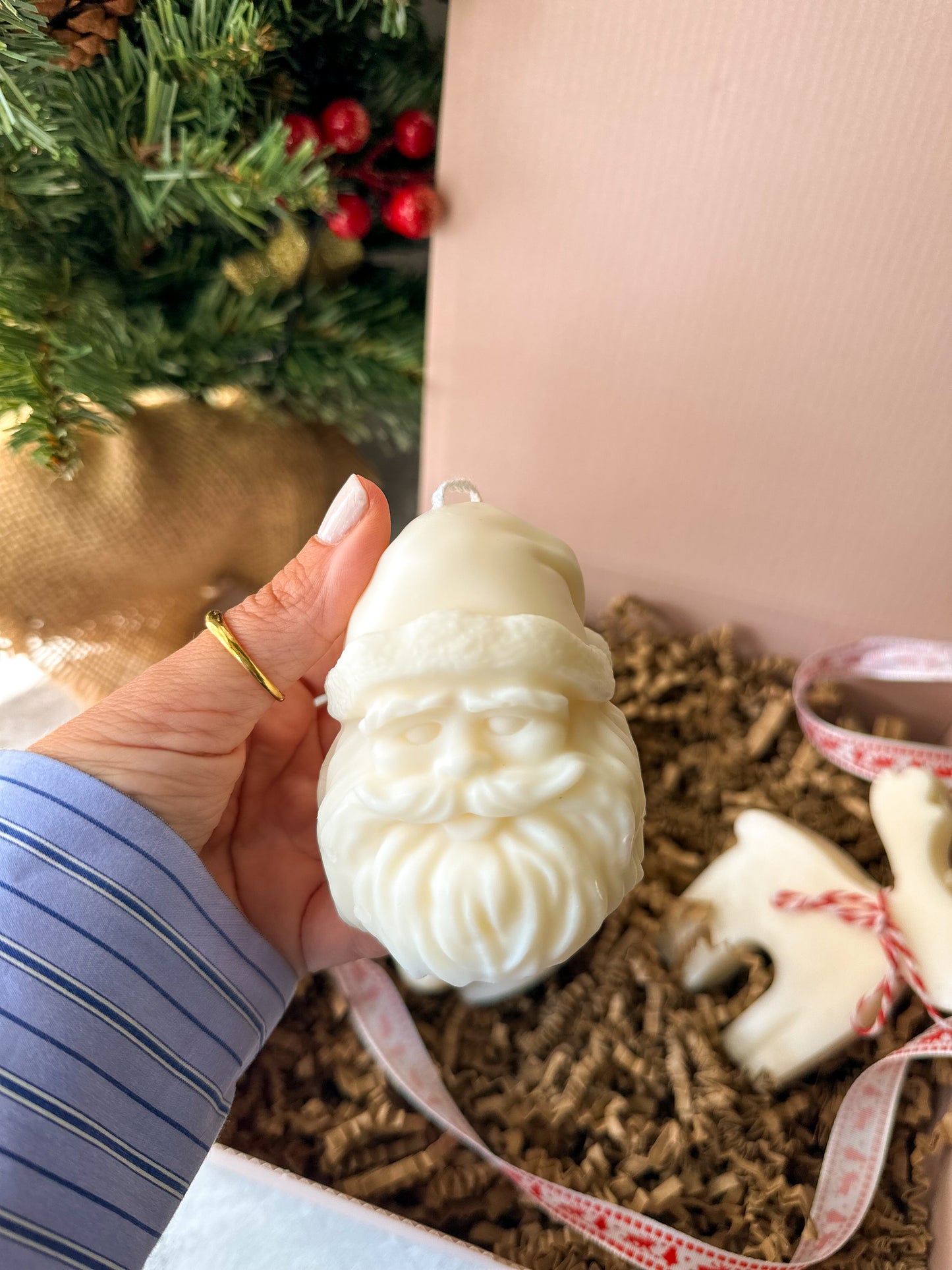 Holding Santa soy wax candles with pink gift box on the back