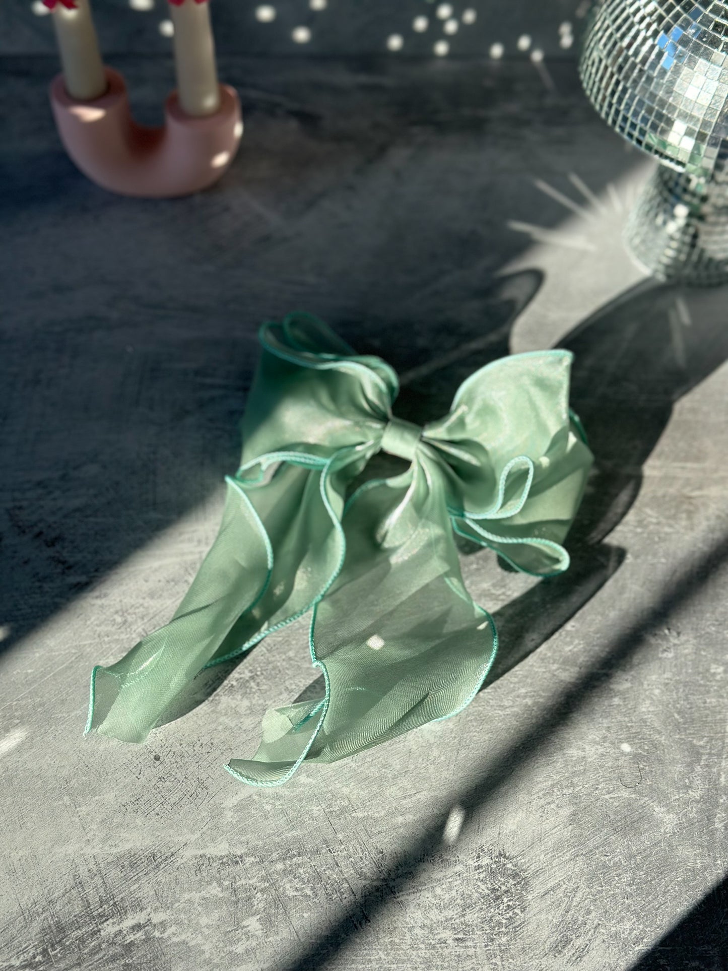 Green Bow Tie Hair Clip on a grey background