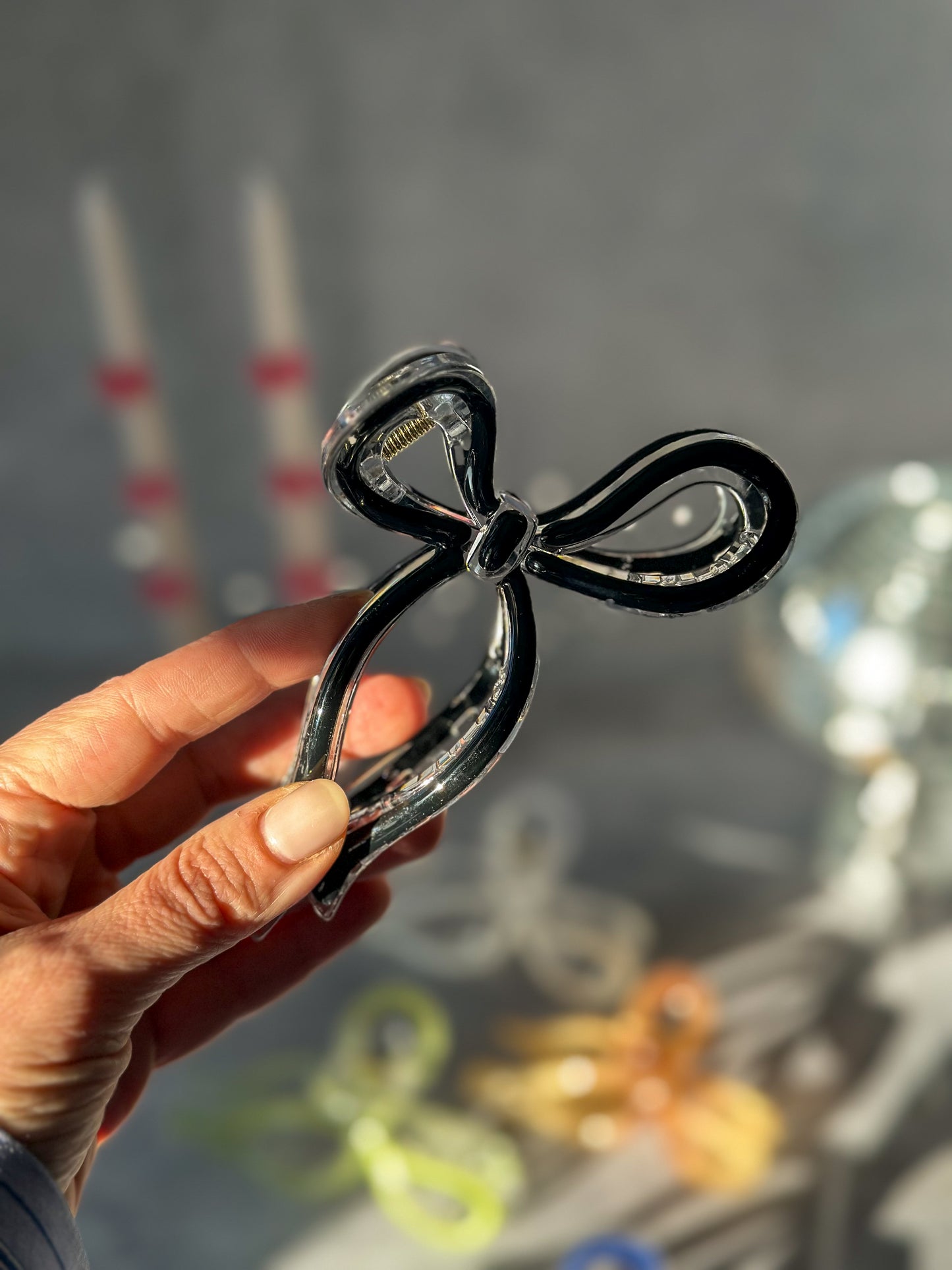 Holding Black Bow Claw Clip