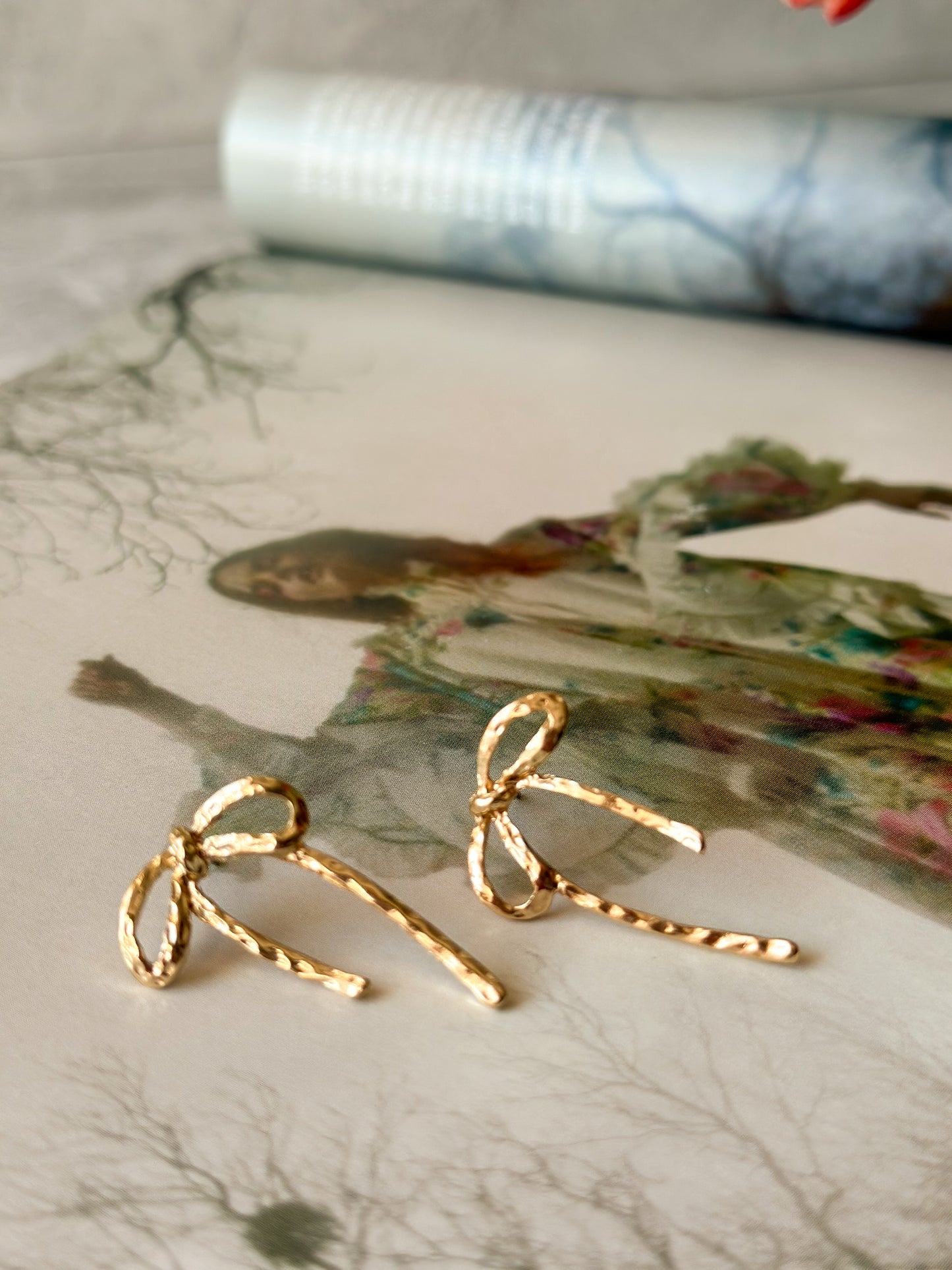 Bow Gold Coloured Earrings on magazine
