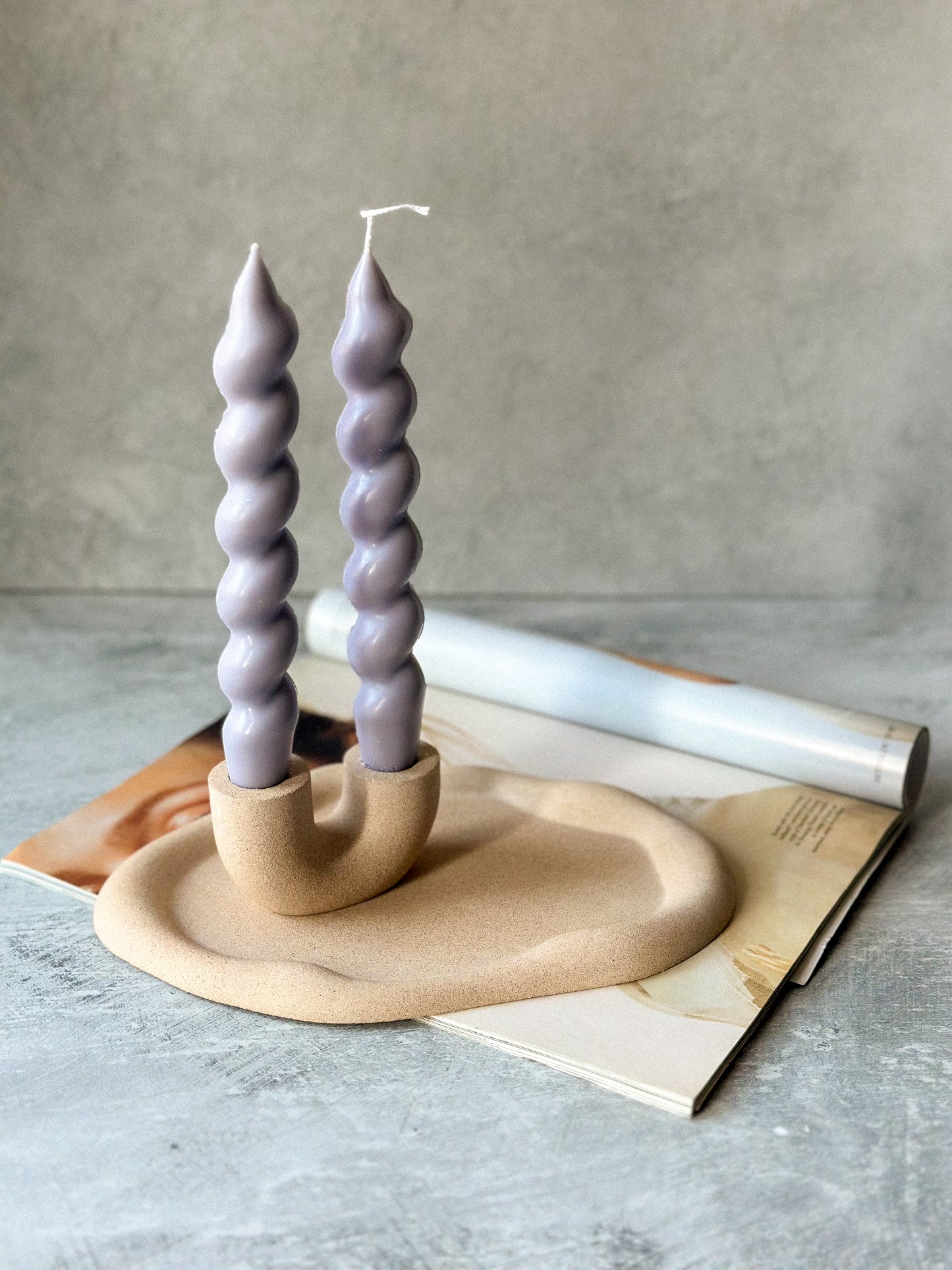 Earthy U Shape Dinner Candle Holder with twisted lavender colour candlesStone Textured on a cloudy oval trinket dish.