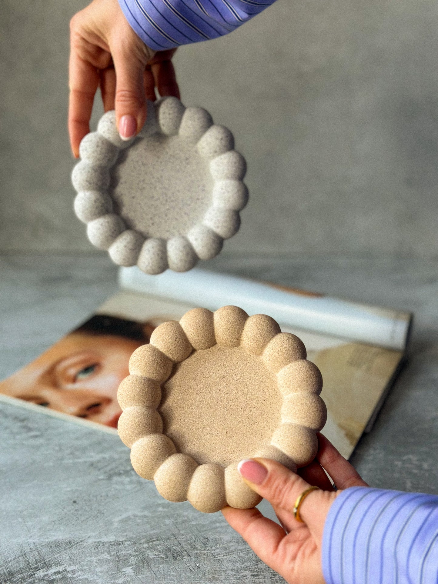Holding Earthy Bubble Stone texture Jewellery Trays and magazine on the backgrounds.