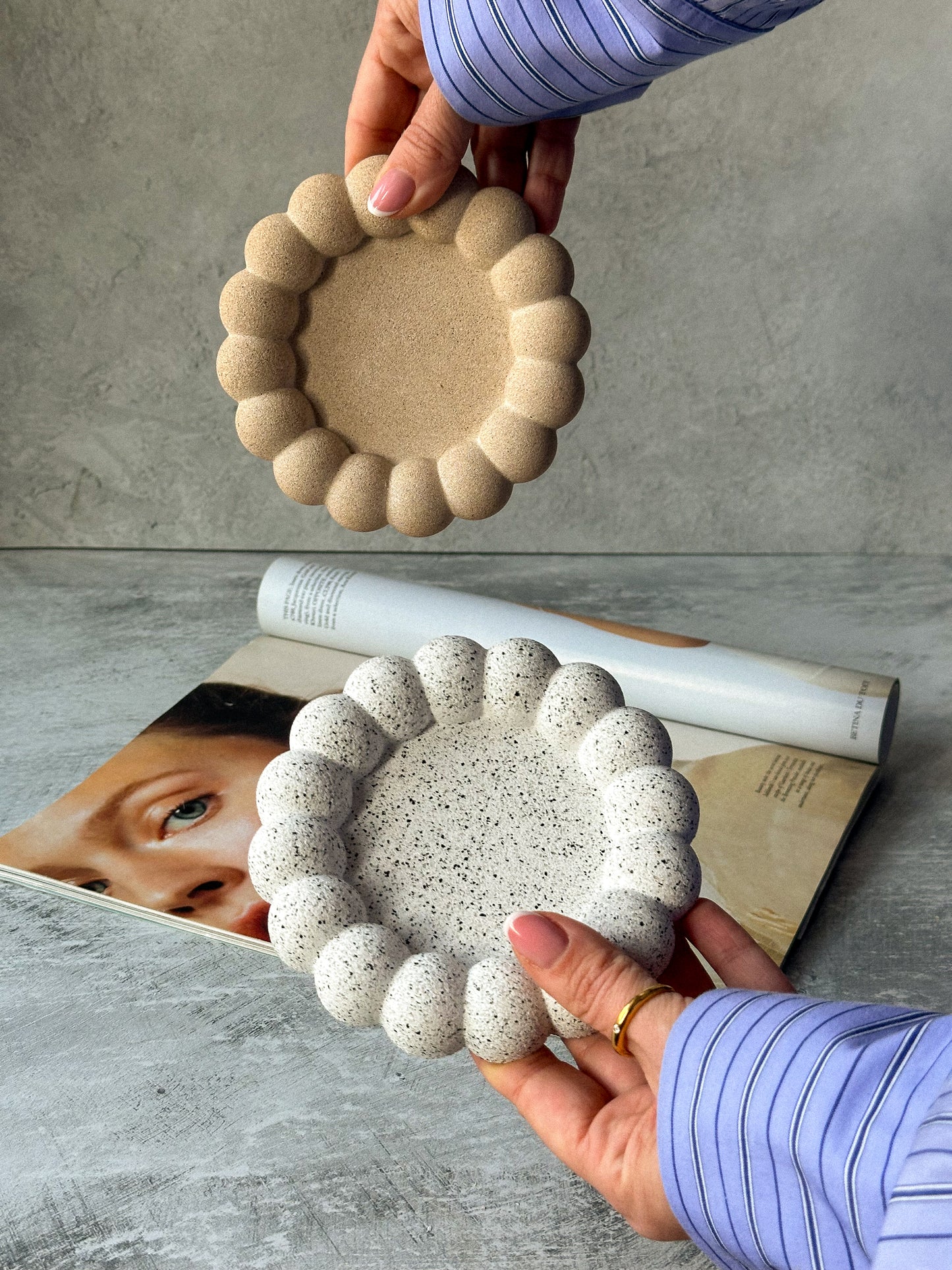 Holding Earthy Bubble Stone texture trinket dishes magazine on the background.