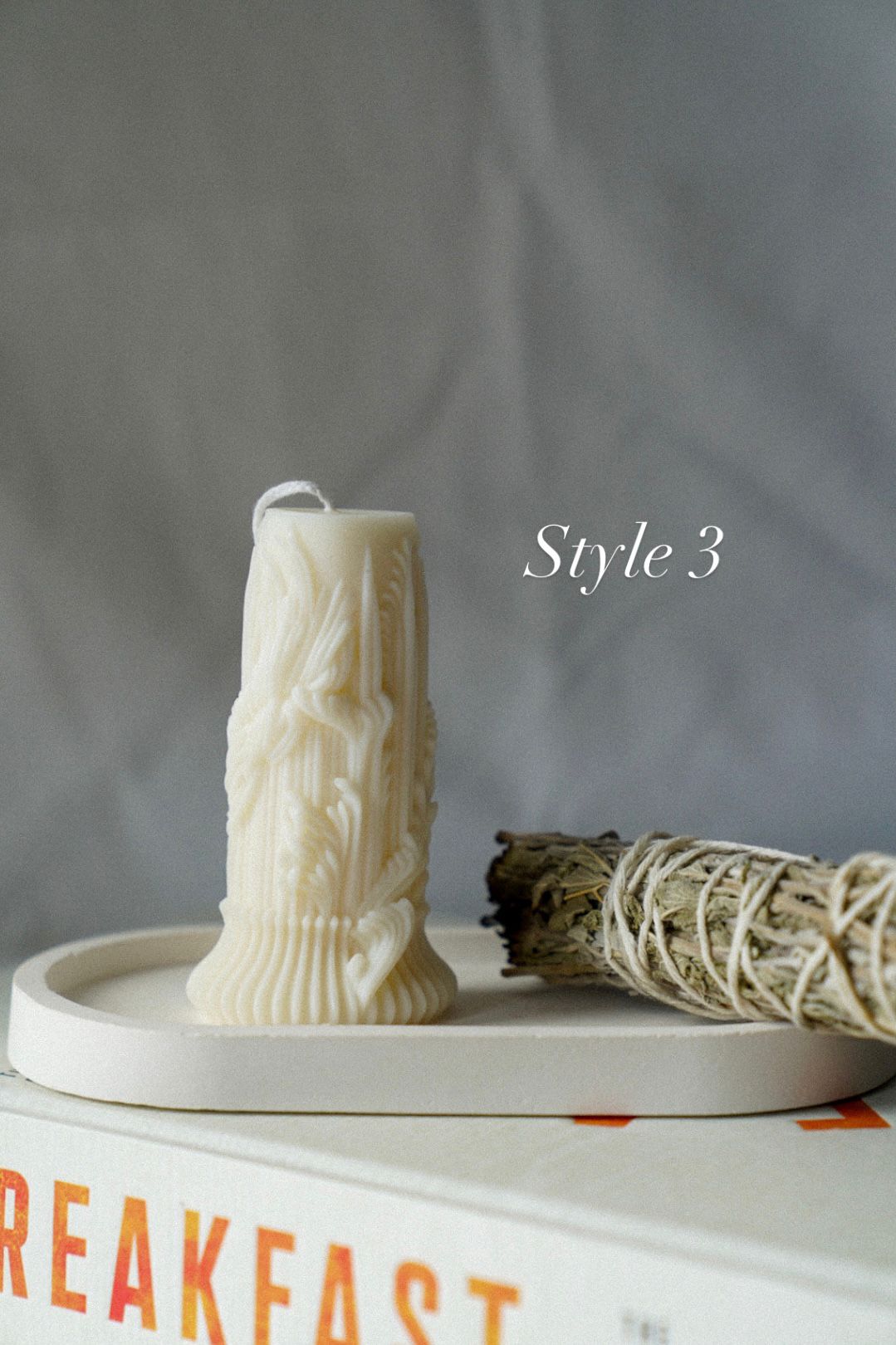 Carved Cylindrical Pillar Candle with sage stick next to it