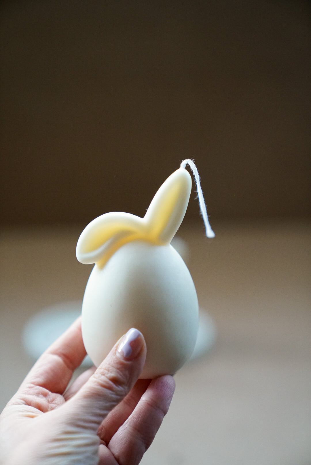 Holding Ivory Easter Bunny Ear Down Candle.