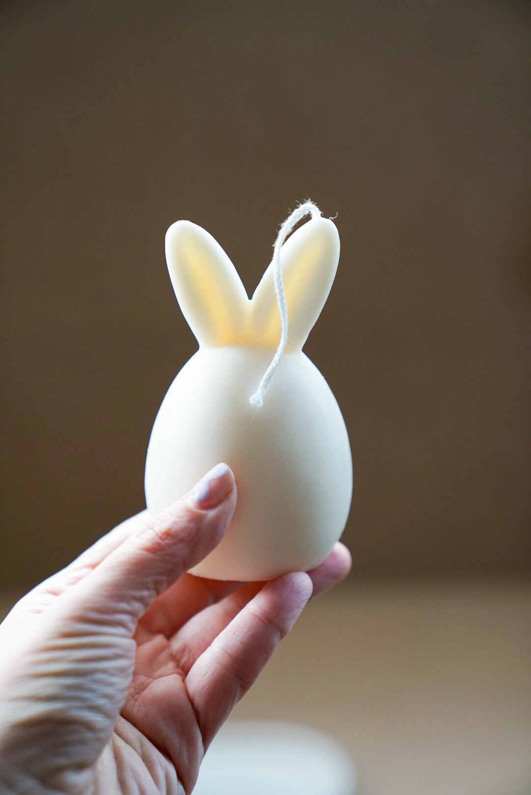Holding Ivory Easter Bunny Ear Up Candle