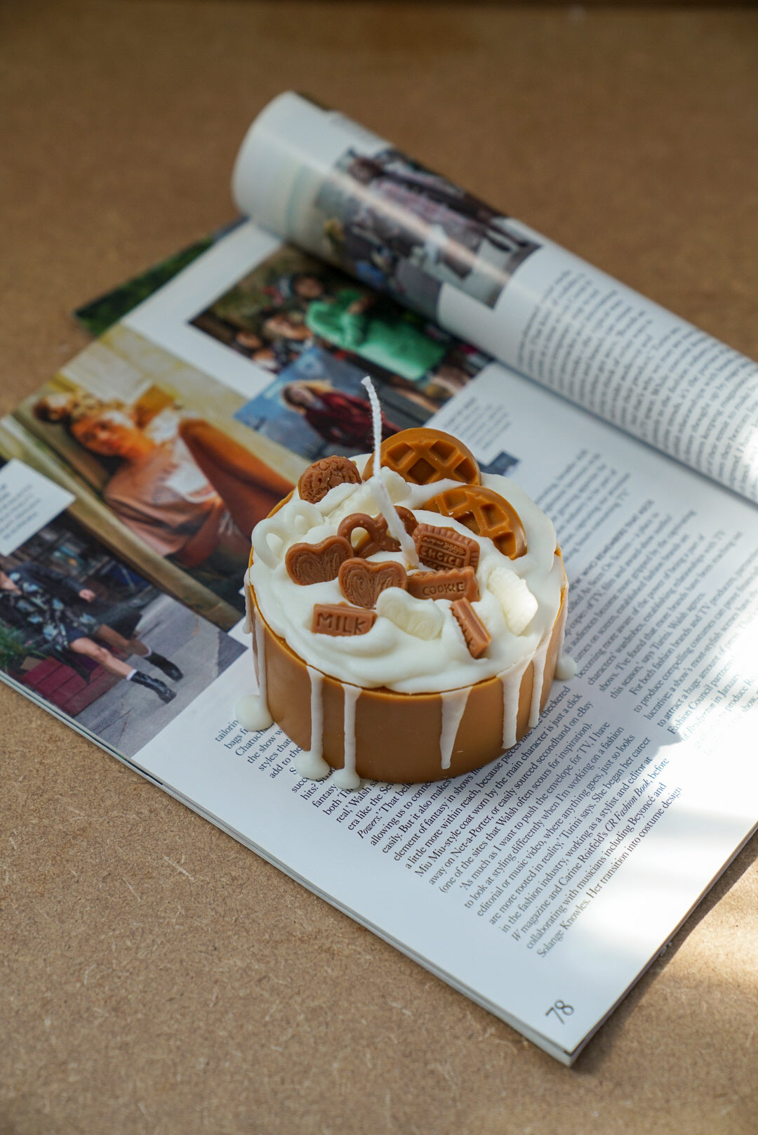 Not edible Lotus Birthday Cake Candle on a magazine.