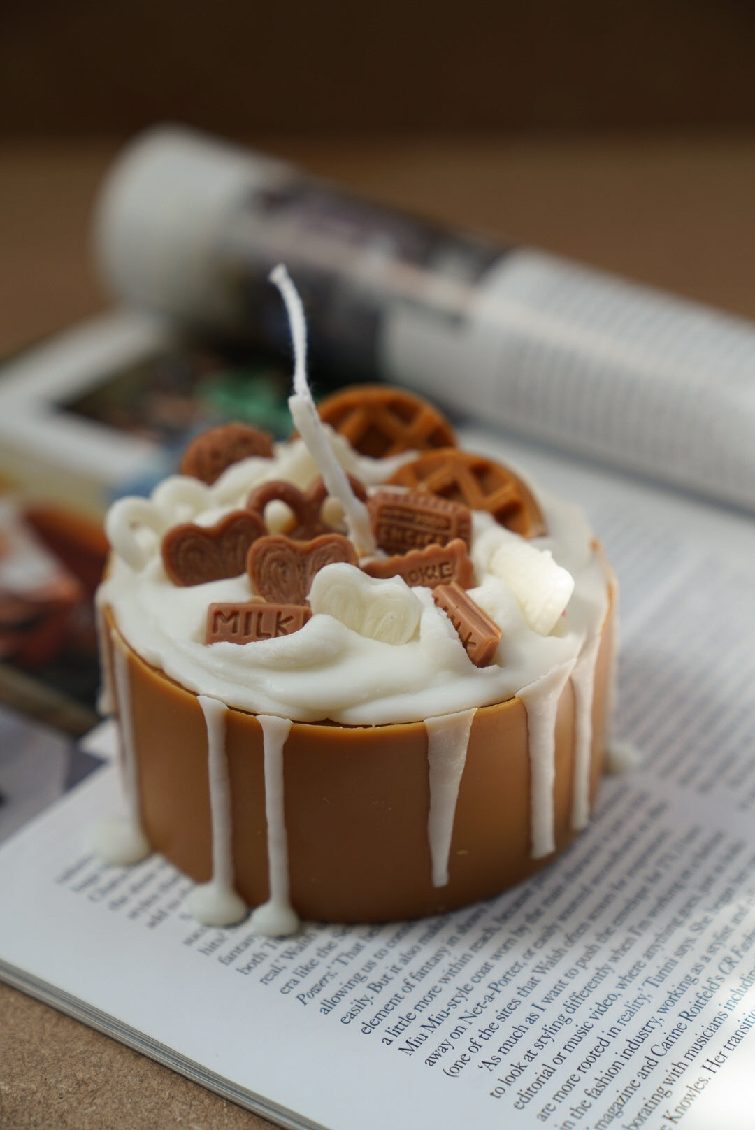 Not edible Lotus Birthday Cake Candle on a magazine.