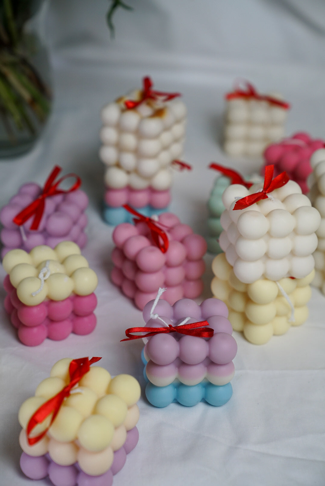Colourful bubble candles with a bow on