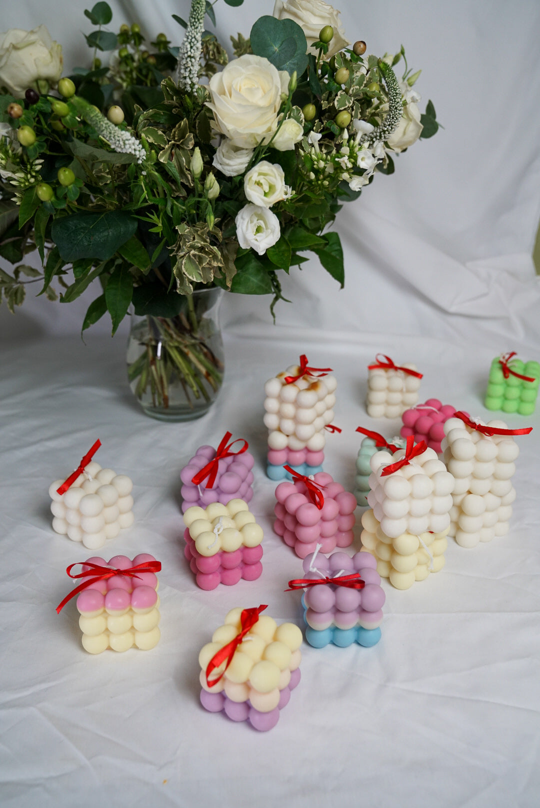 Colourful bubble candle with bunch of flower
