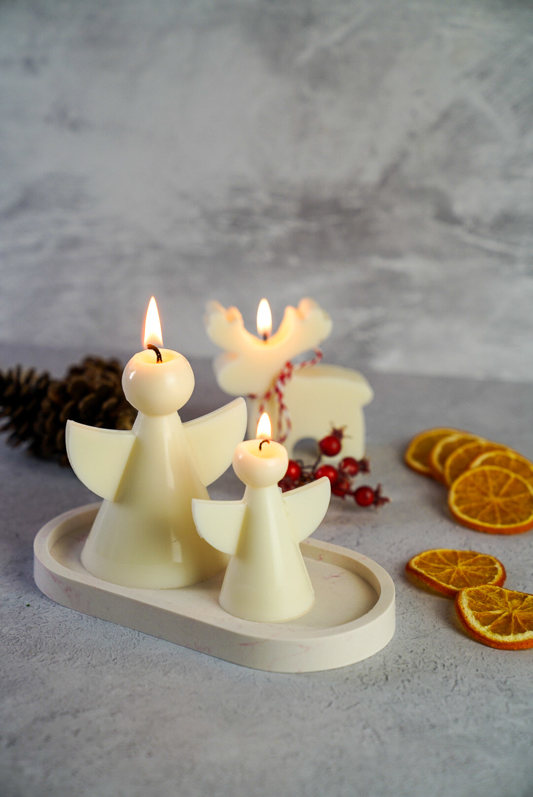 Christmas Angel Candles Set, on the back reindeer candles dry orange on the side.