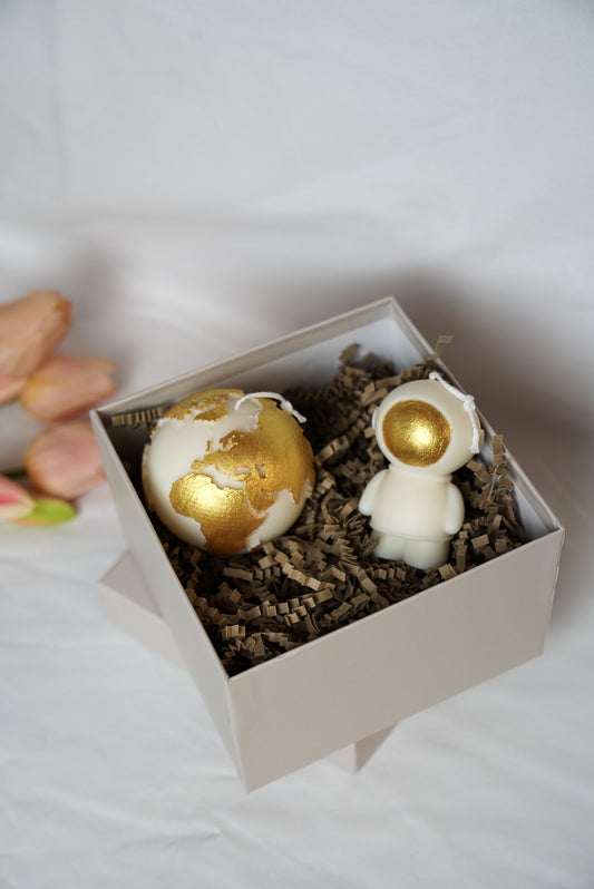 Ivory Space Man & Globe Candle gold painted in a gift box with white background