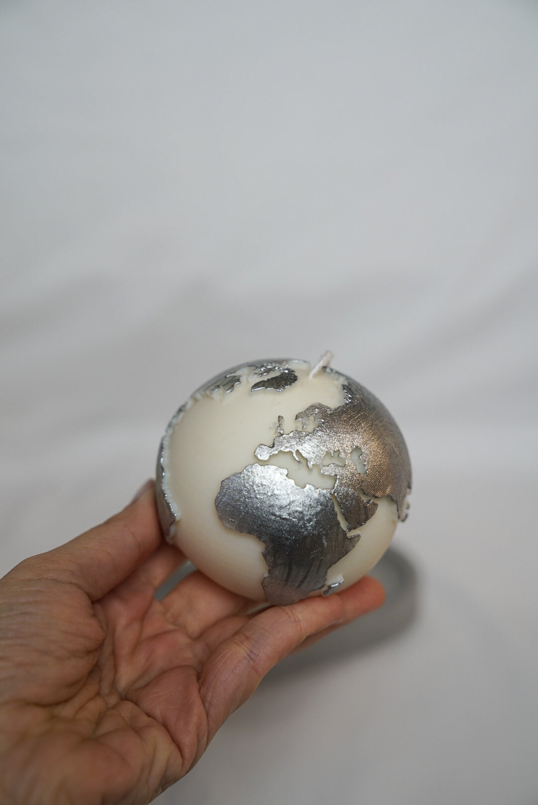 Holding Globe Candle with silver painted.