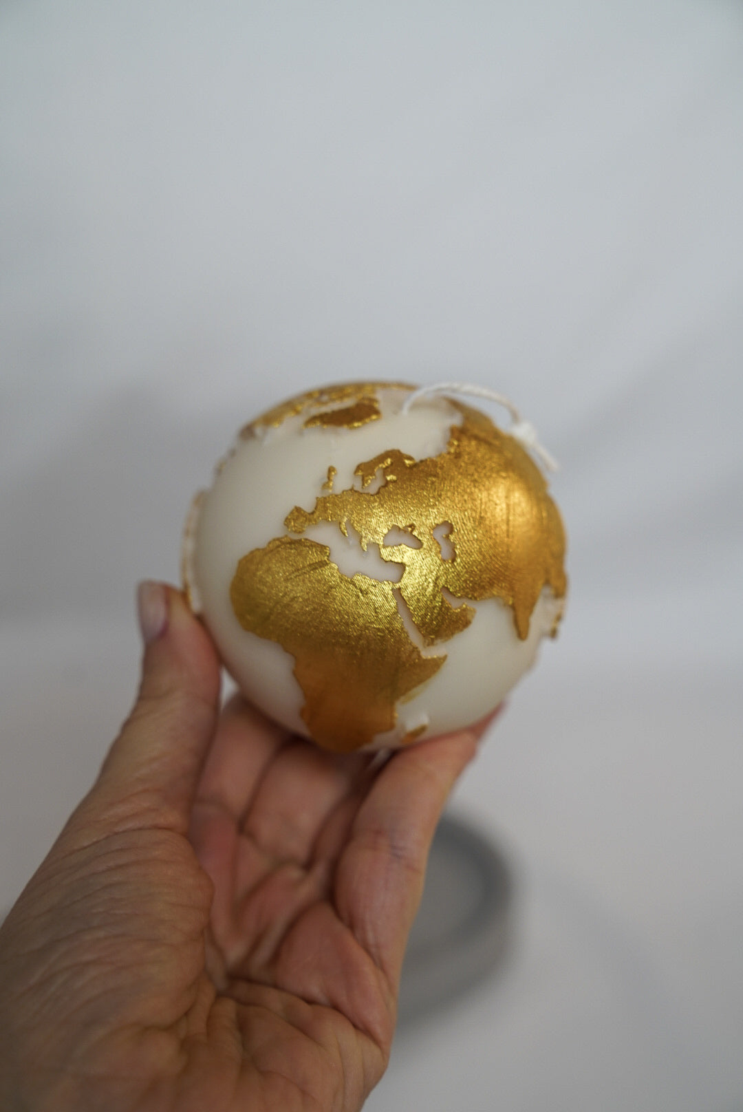 Holding Globe Candle with gold painted.