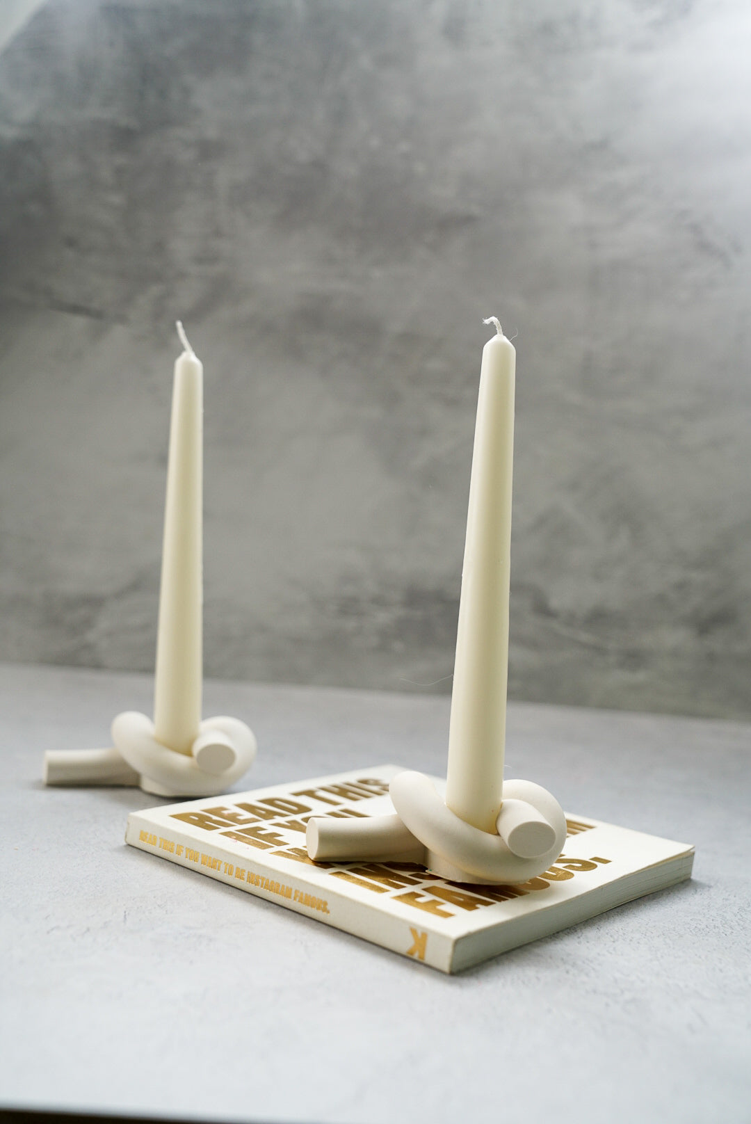 Knot Shaped Candle Holder with long candles on them.