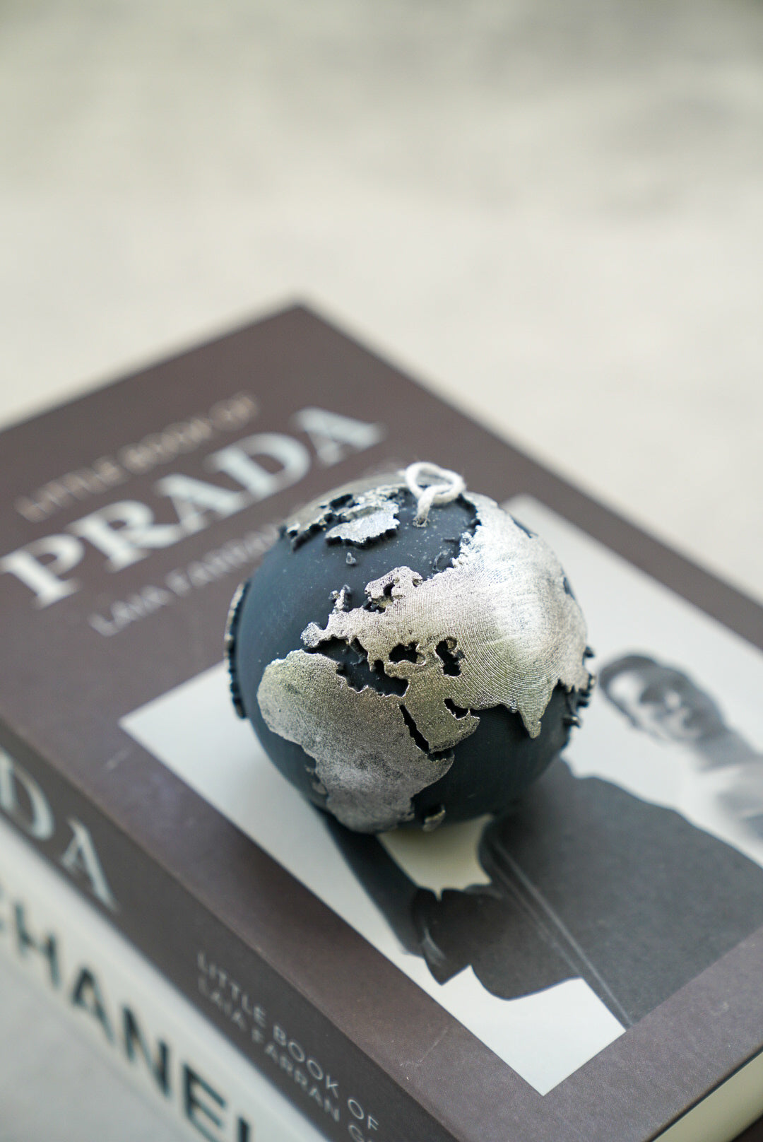 Black Globe Candle with silver painted on a magazine.