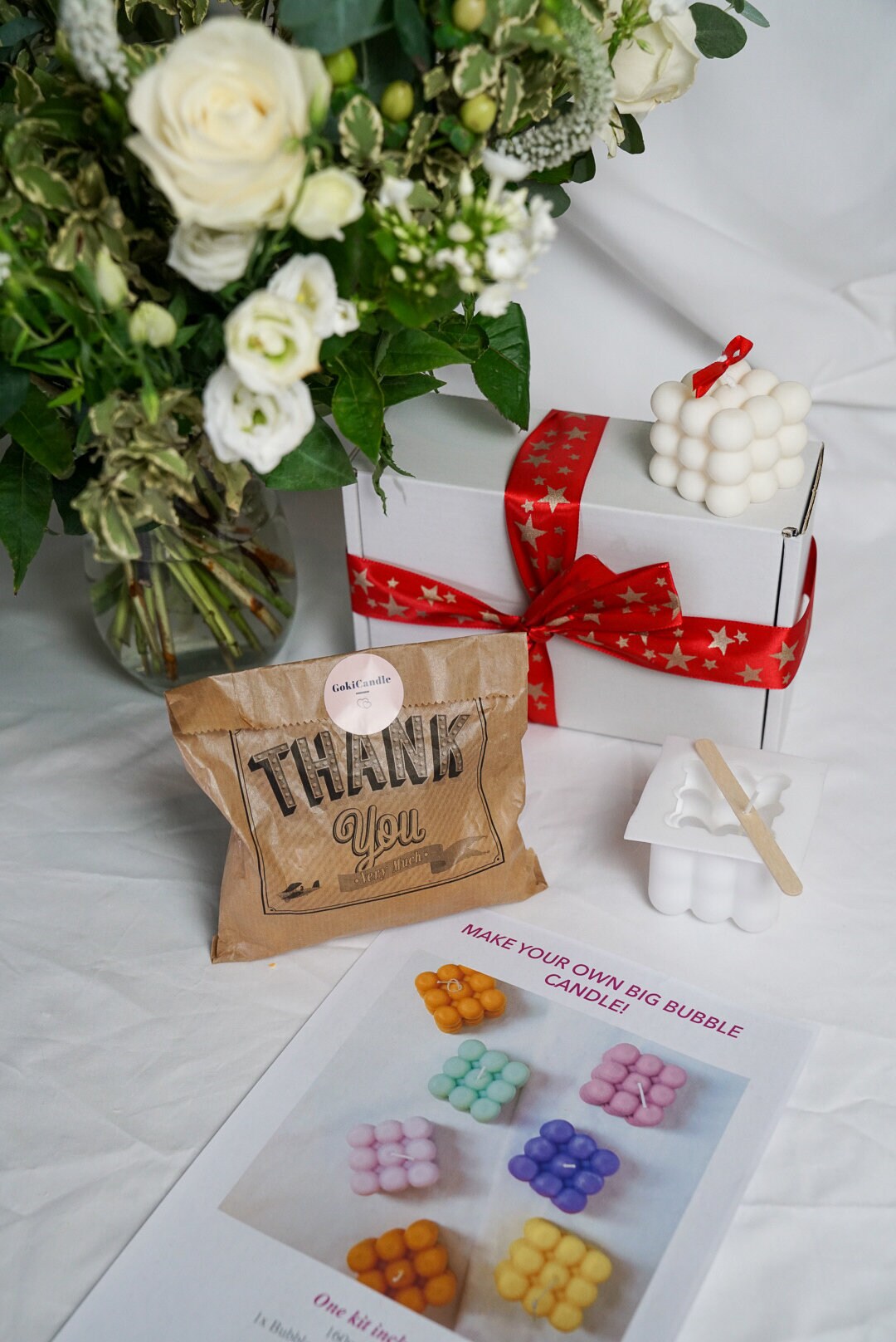 Make your own big Bubble Candle Making Kit with some bubble candles around and flowers on the background.